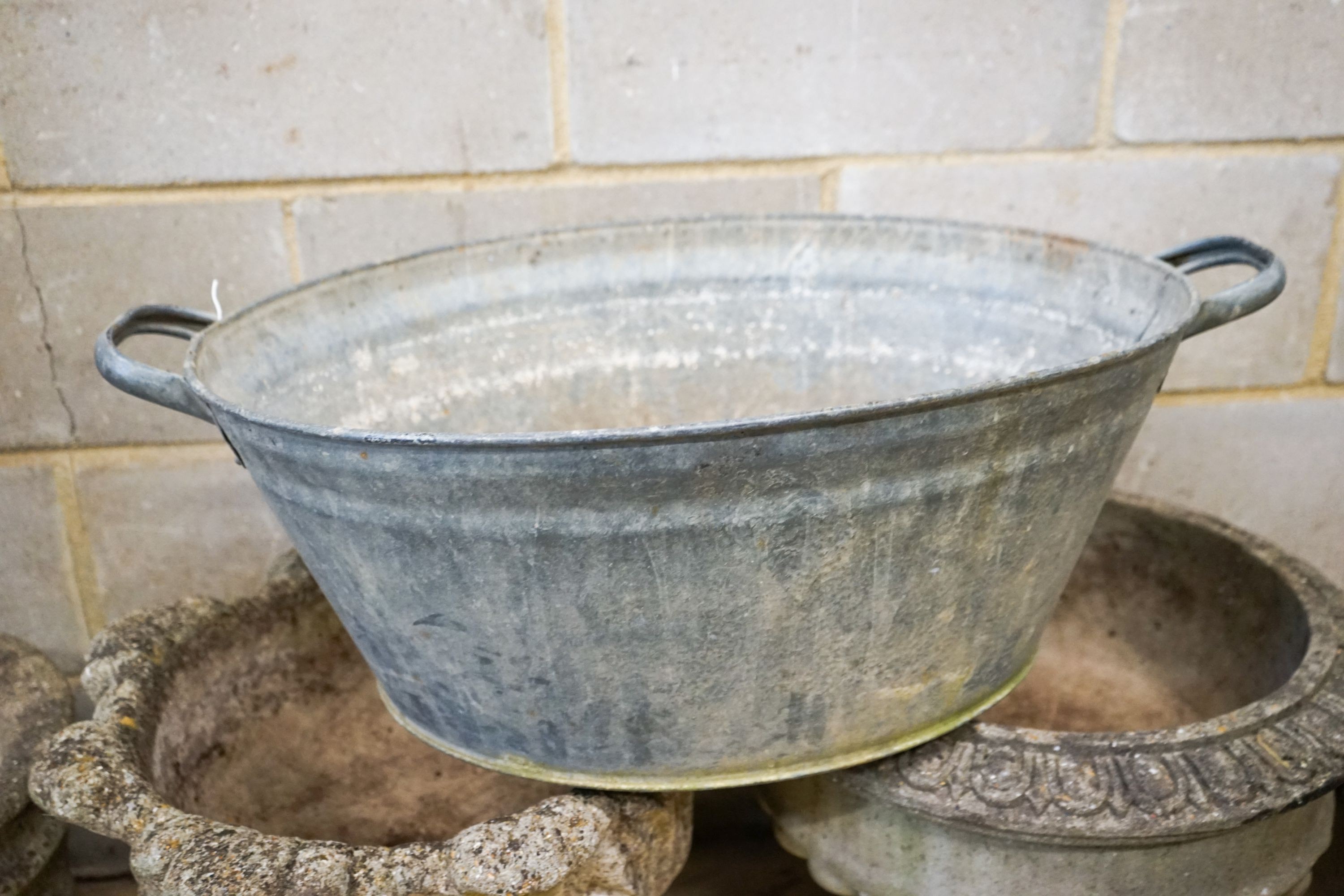Four assorted reconstituted stone garden urns and a galvanised tub